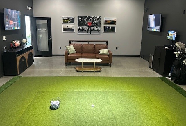 Full Swing golf simulator screen and lounge seating at Swing 365 Richmond — private indoor golf simulator near Richmond, TX